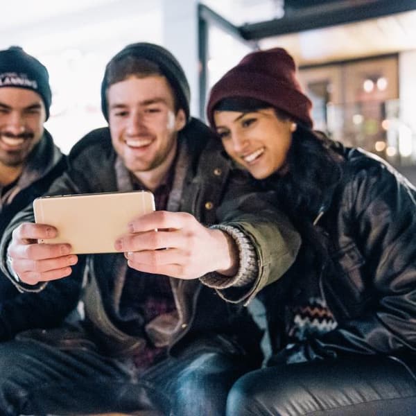 Friends laughing while taking a photo together